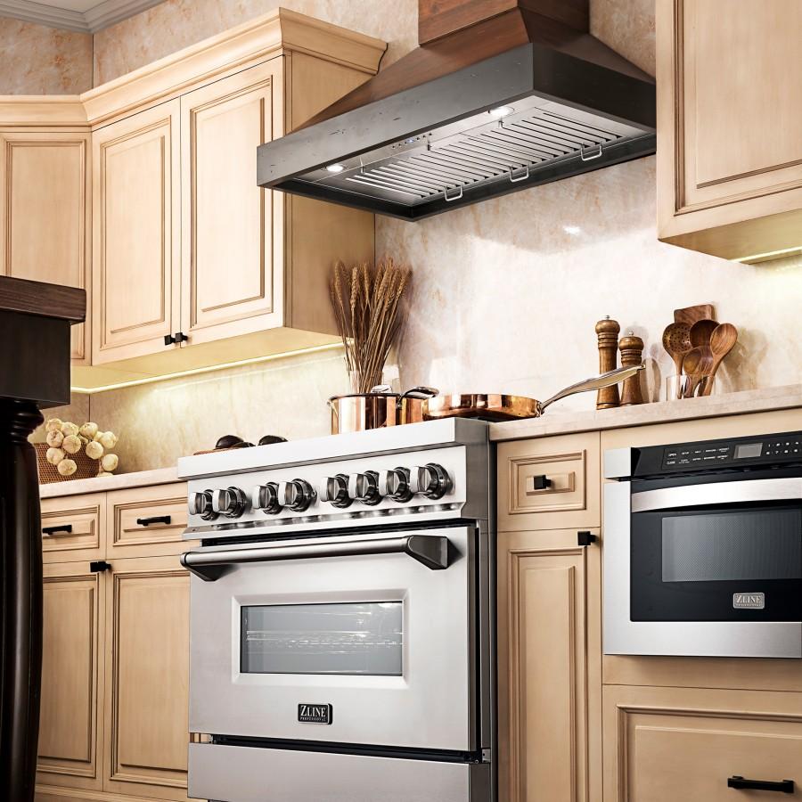 Wood wall range hood with stainless vent canopy over a cooktop