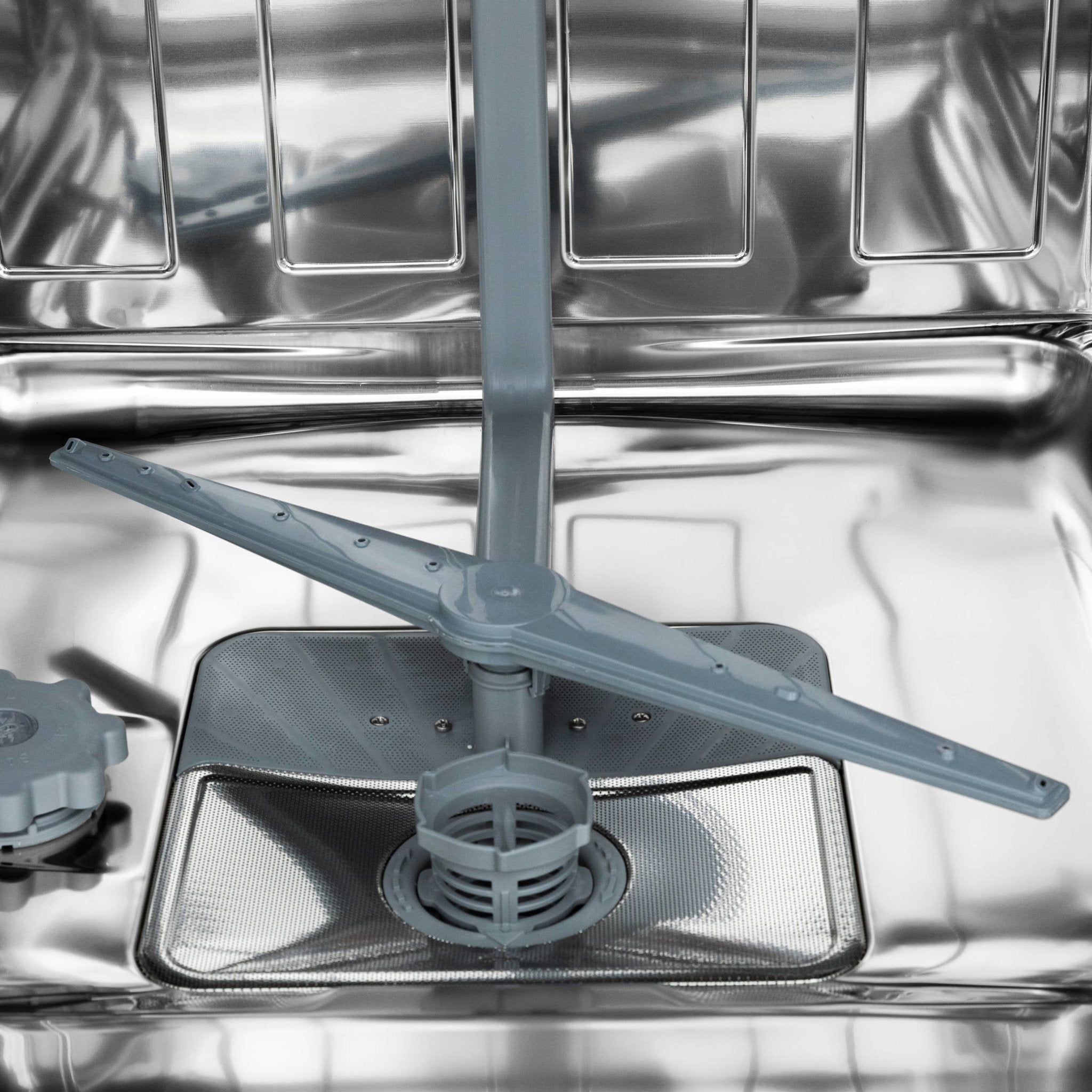 Dishwasher tub with utensil basket insert and metal rack rails inside stainless interior.