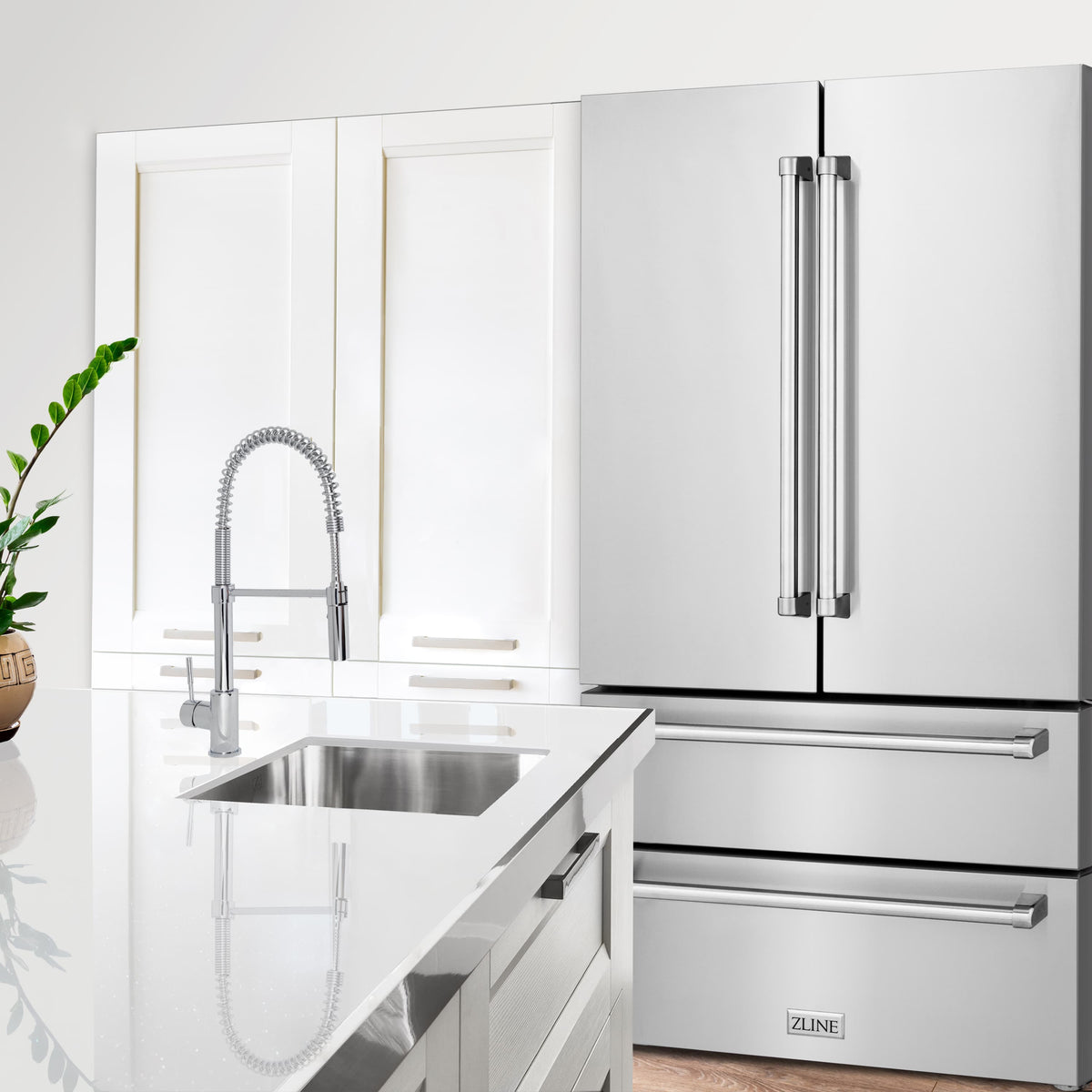 Kitchen appliance package featuring a white range hood, oven, and stainless refrigerator