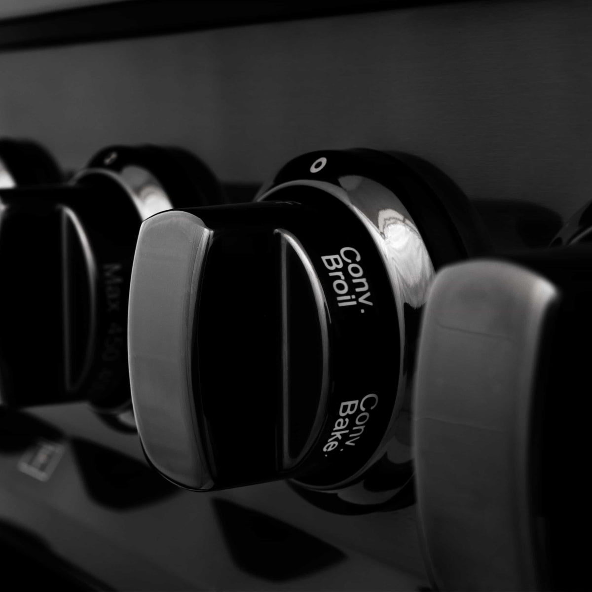 ZLINE burner knob set on black control panel with glossy finish