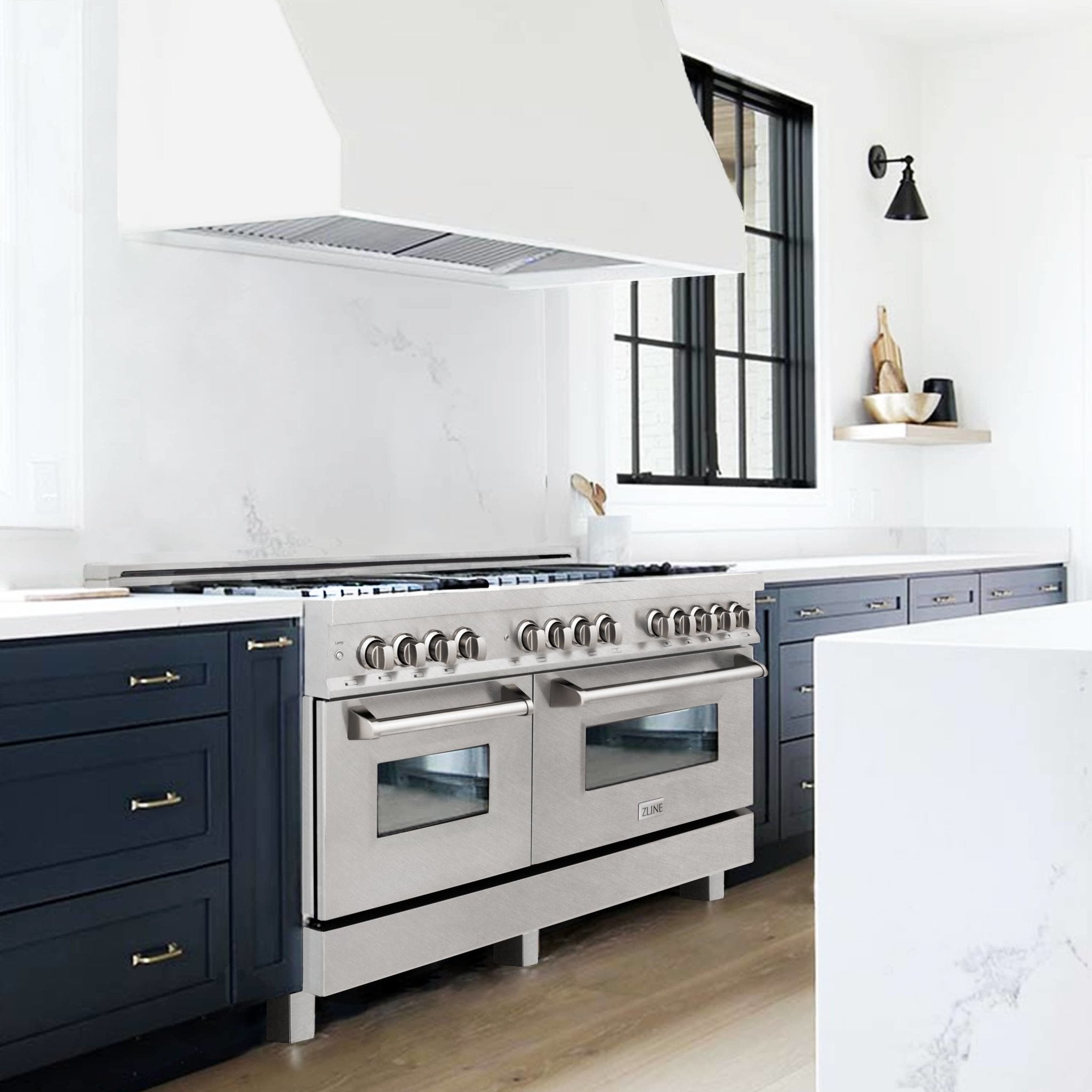 Stainless steel dual fuel range with open vent hood and front oven doors