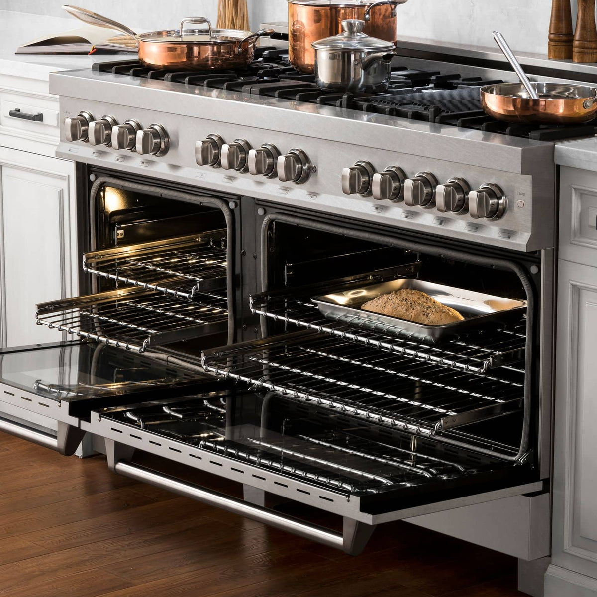 Dual fuel range in satin stainless steel, burners and oven racks visible in open doors