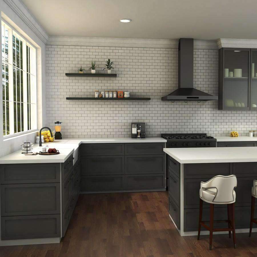 Matte black kitchen faucet over a white sink with side sprayer