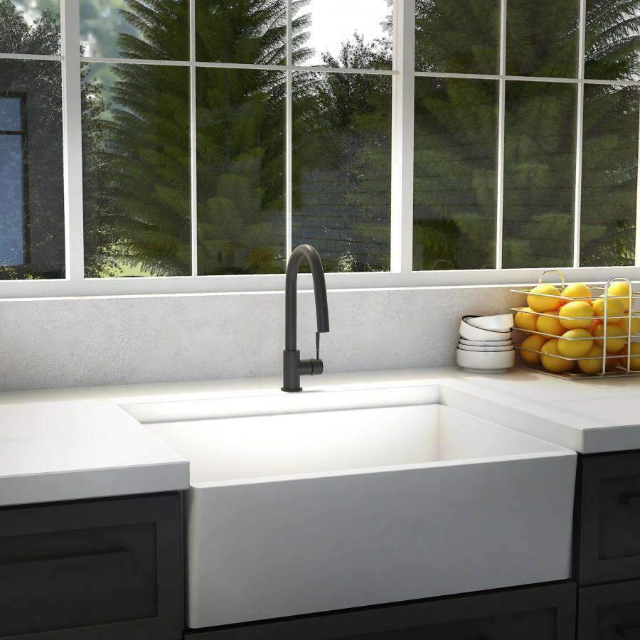 Matte black kitchen faucet with tall arched spout and compact side sprayer