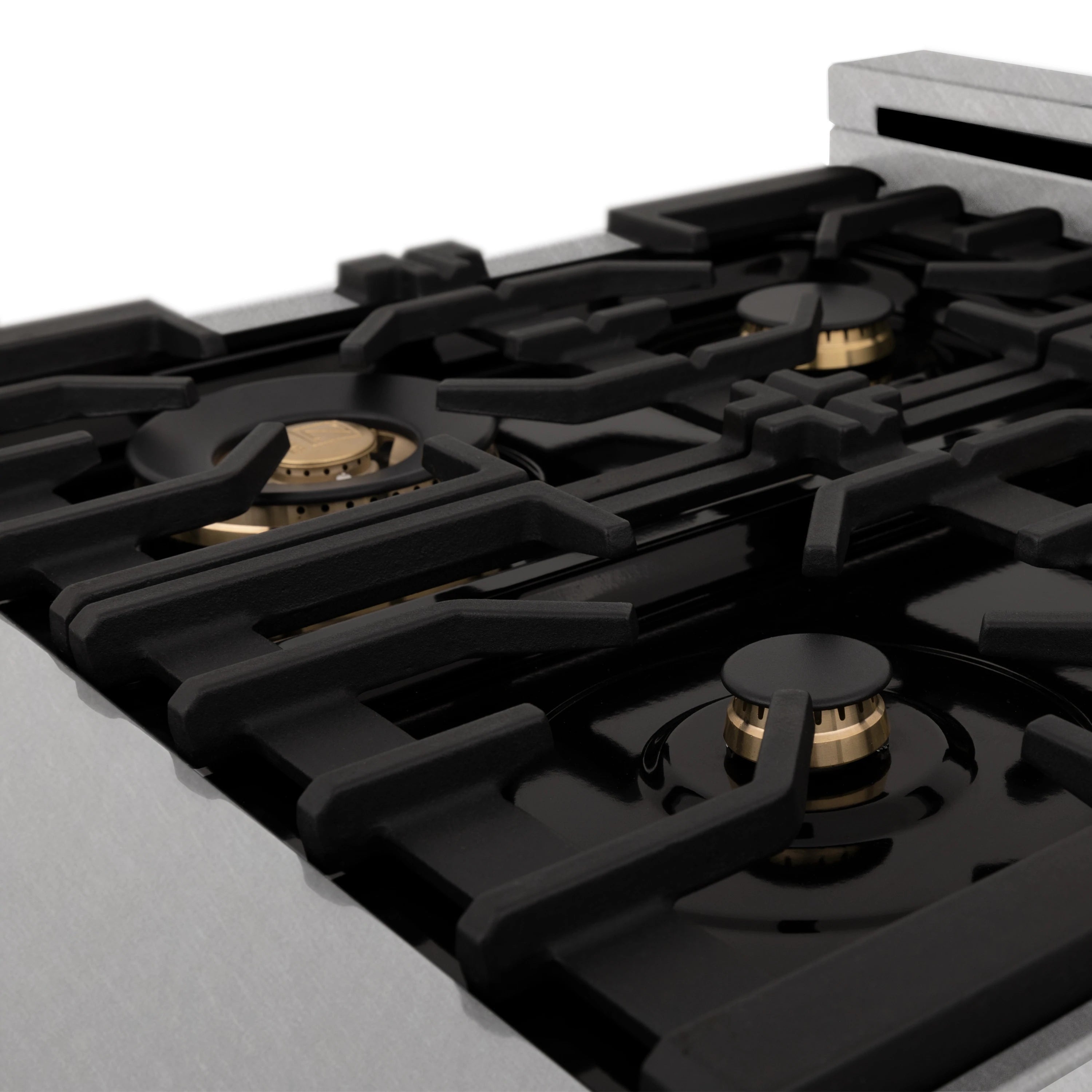 Close-up of black cast-iron gas grates and burner heads with gold accents