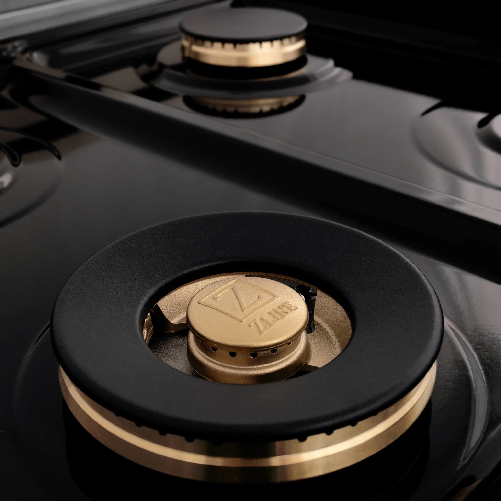 Gas cooktop burner with bronze control knob and black ring