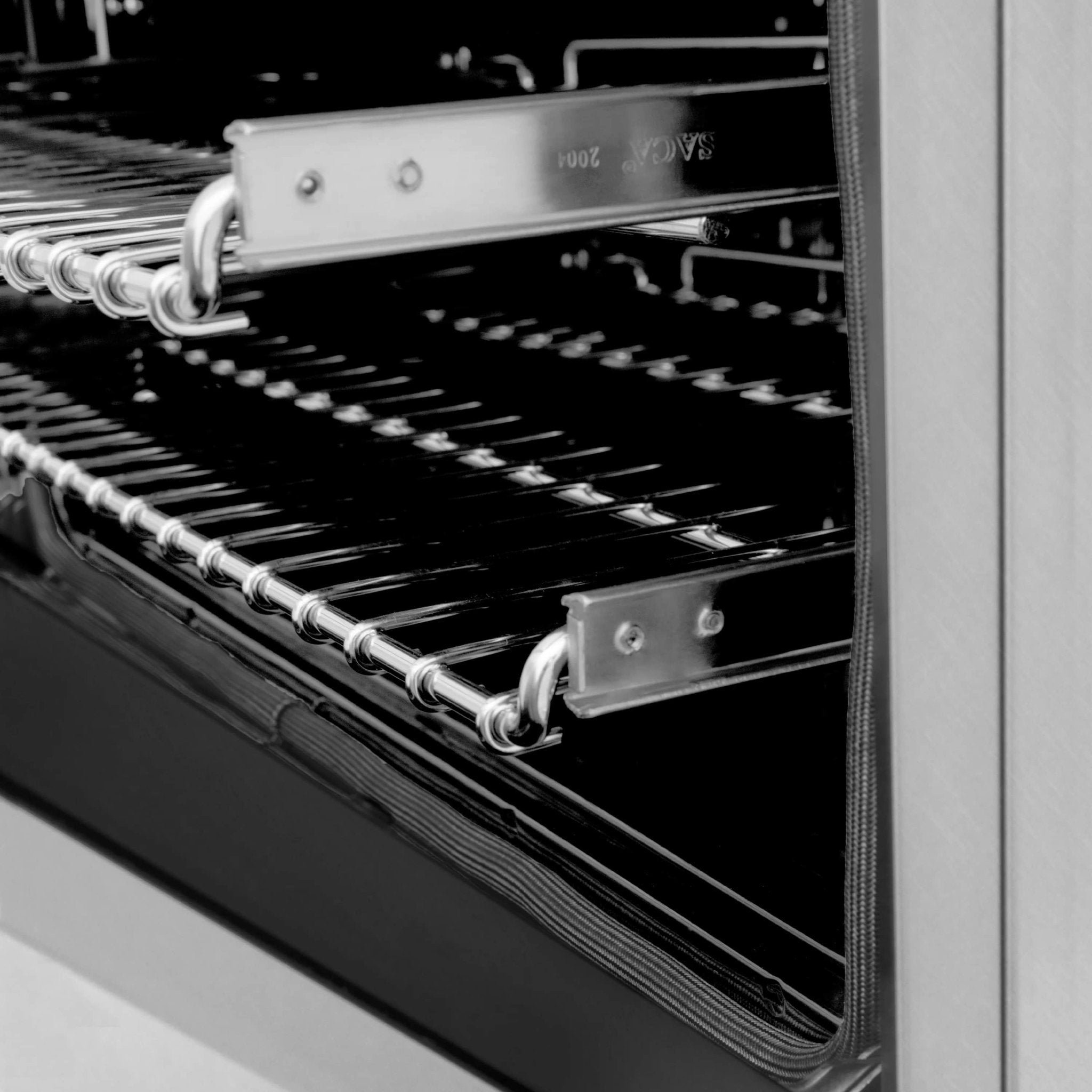 Open oven interior with racks and metal rails