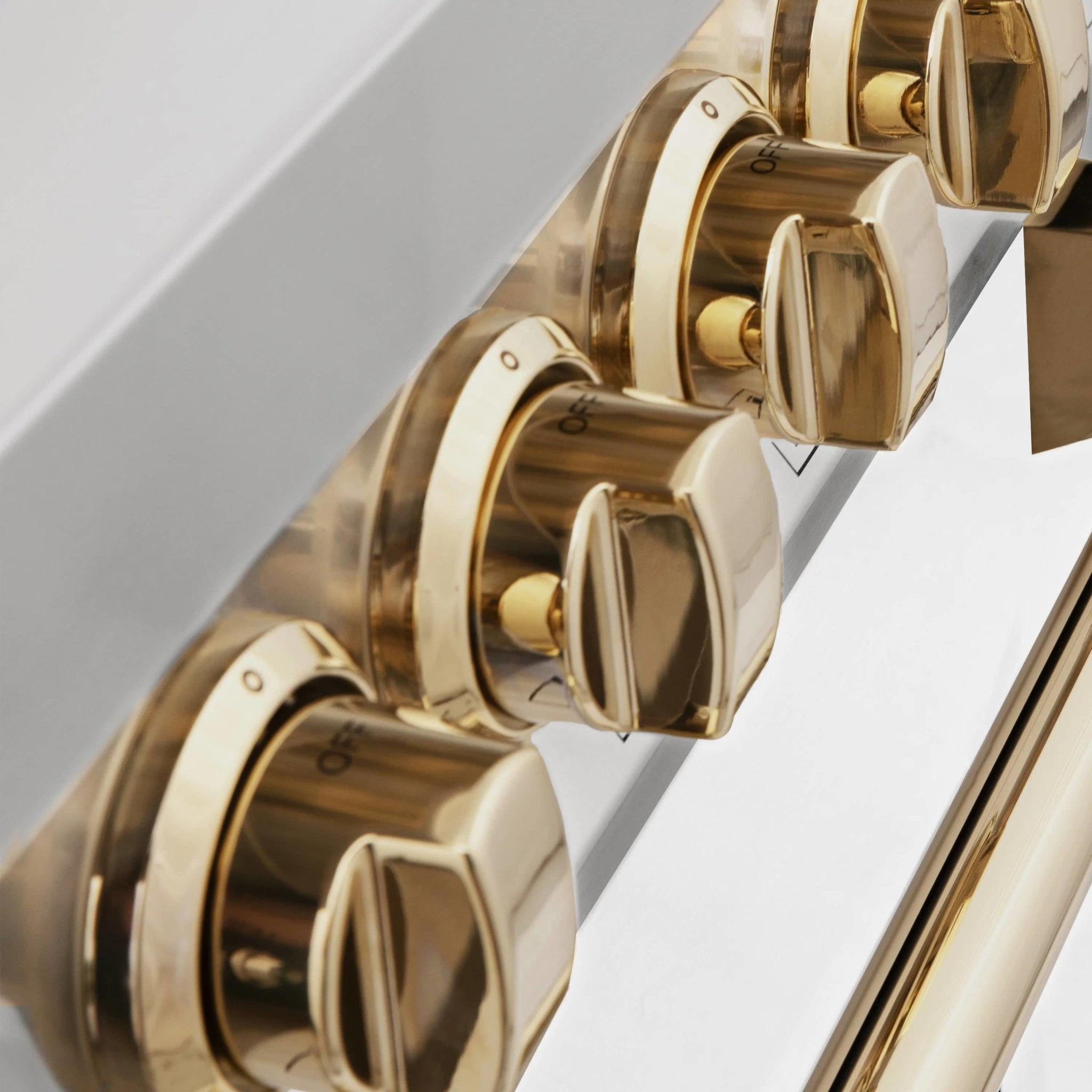 Gold rotary oven control knobs with brushed metal trim