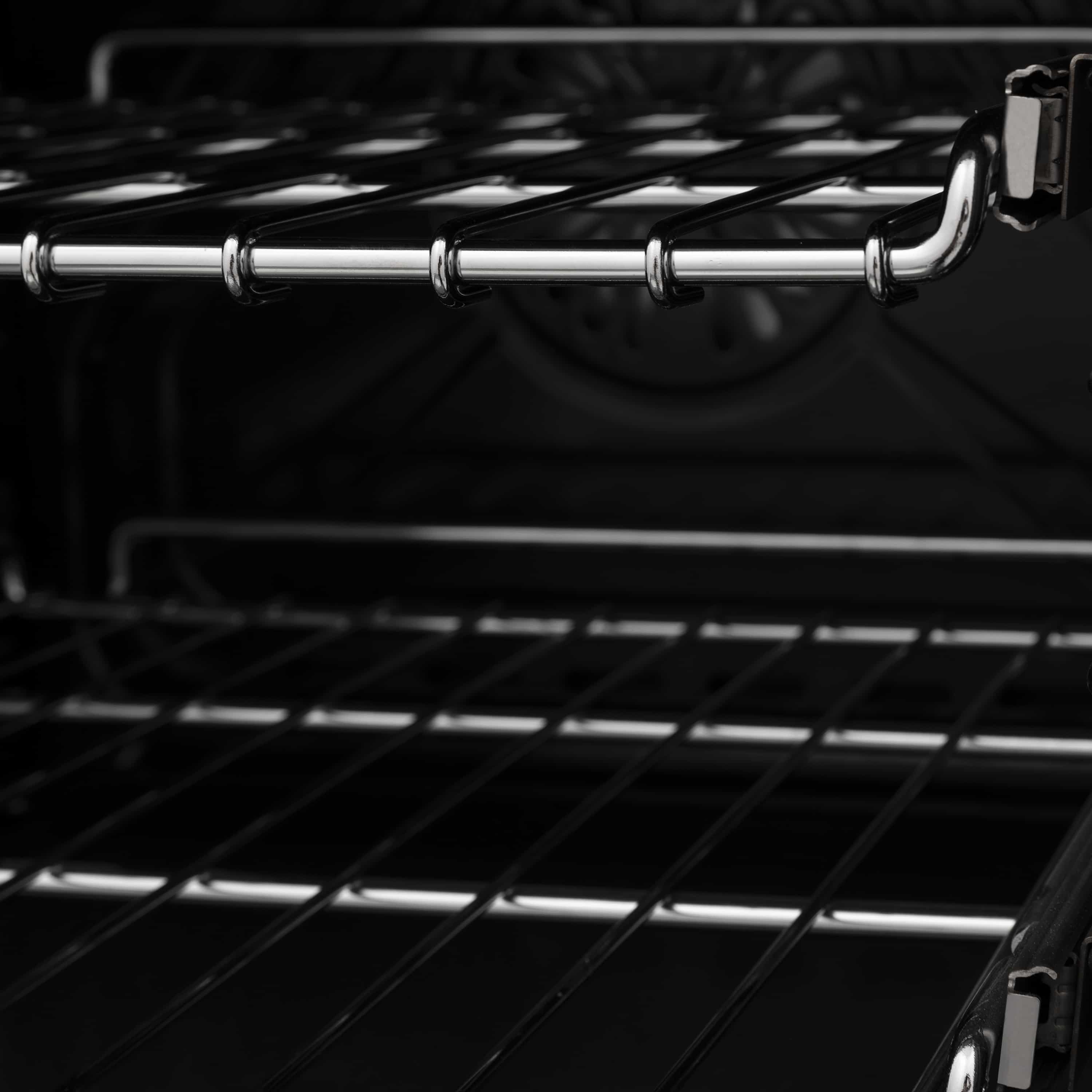 Electric oven interior rack with chrome rails and black oven walls