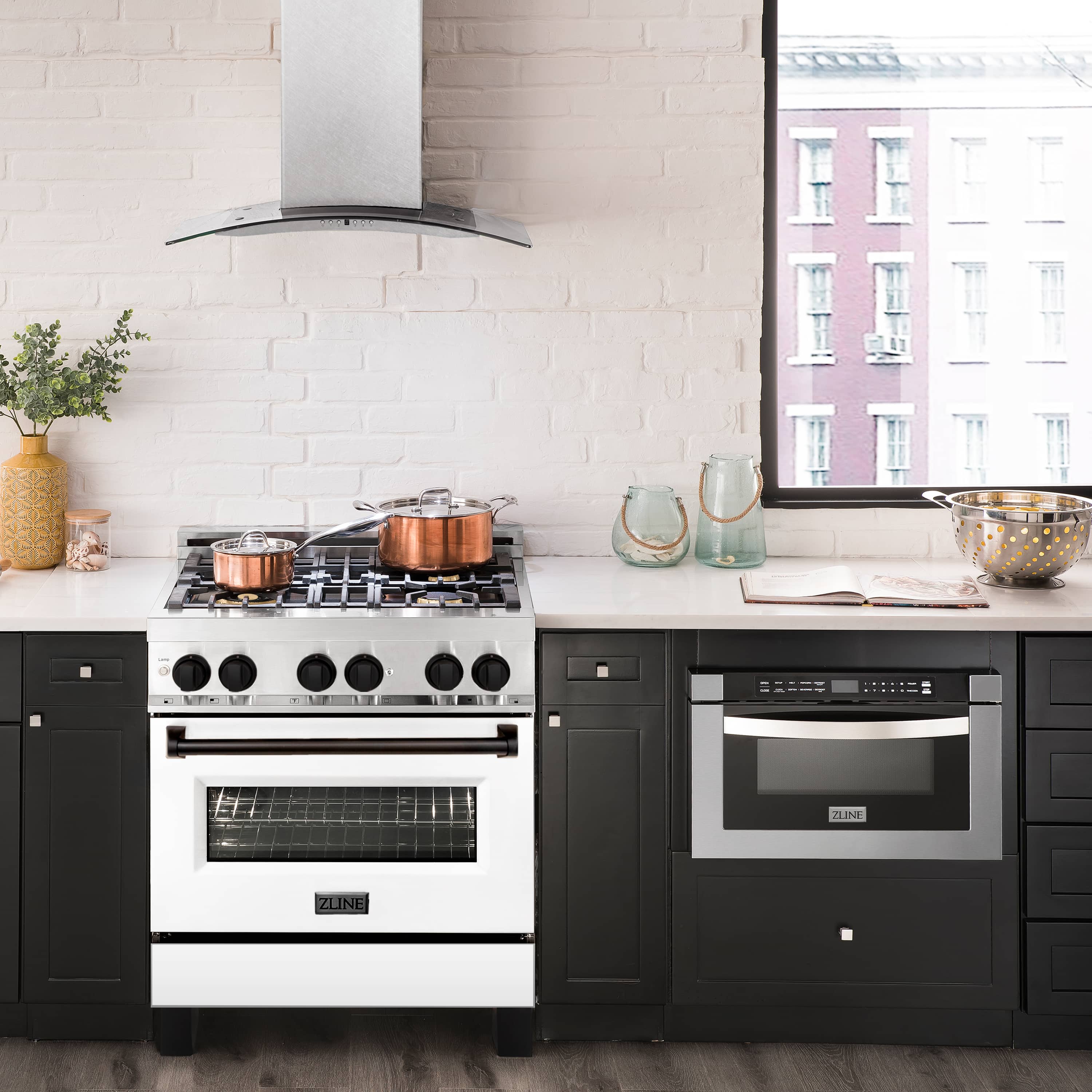 White and stainless dual fuel range in a kitchen with built-in oven and cooktop burners