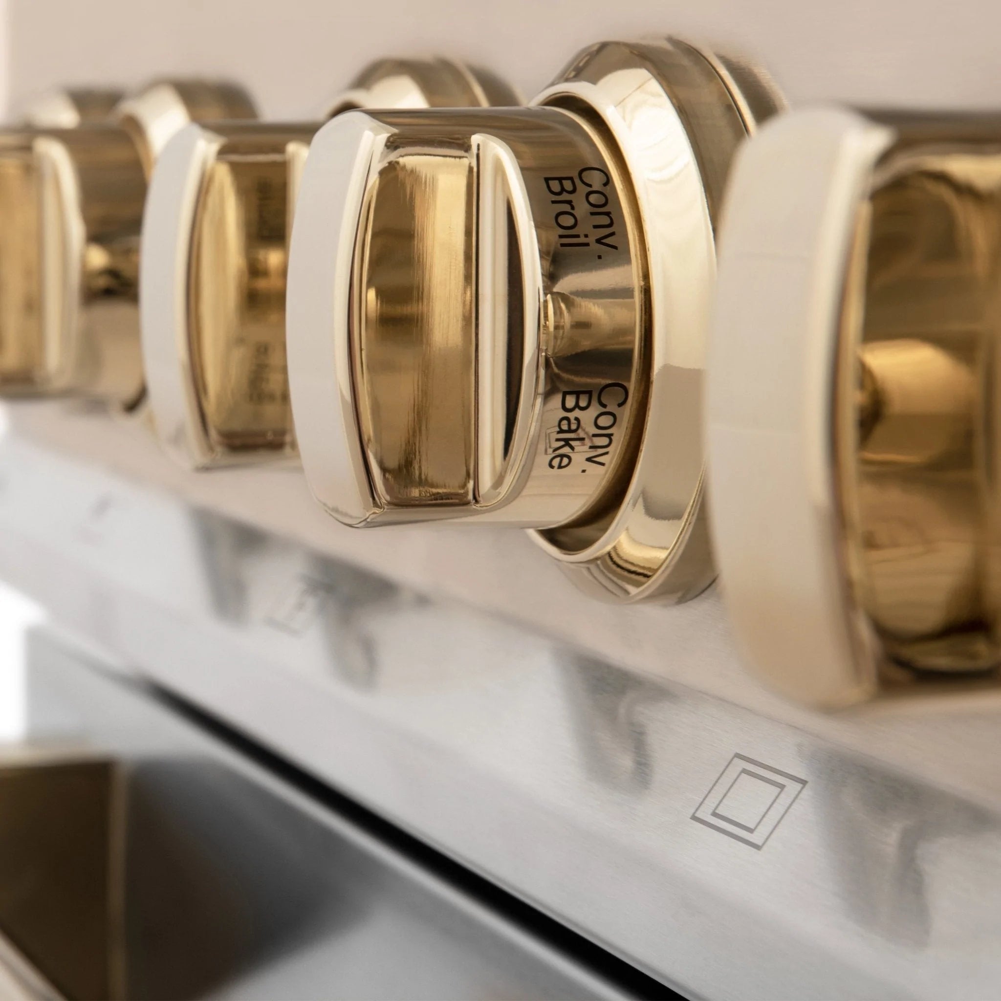 Gold burner control knobs on stainless steel dual fuel range
