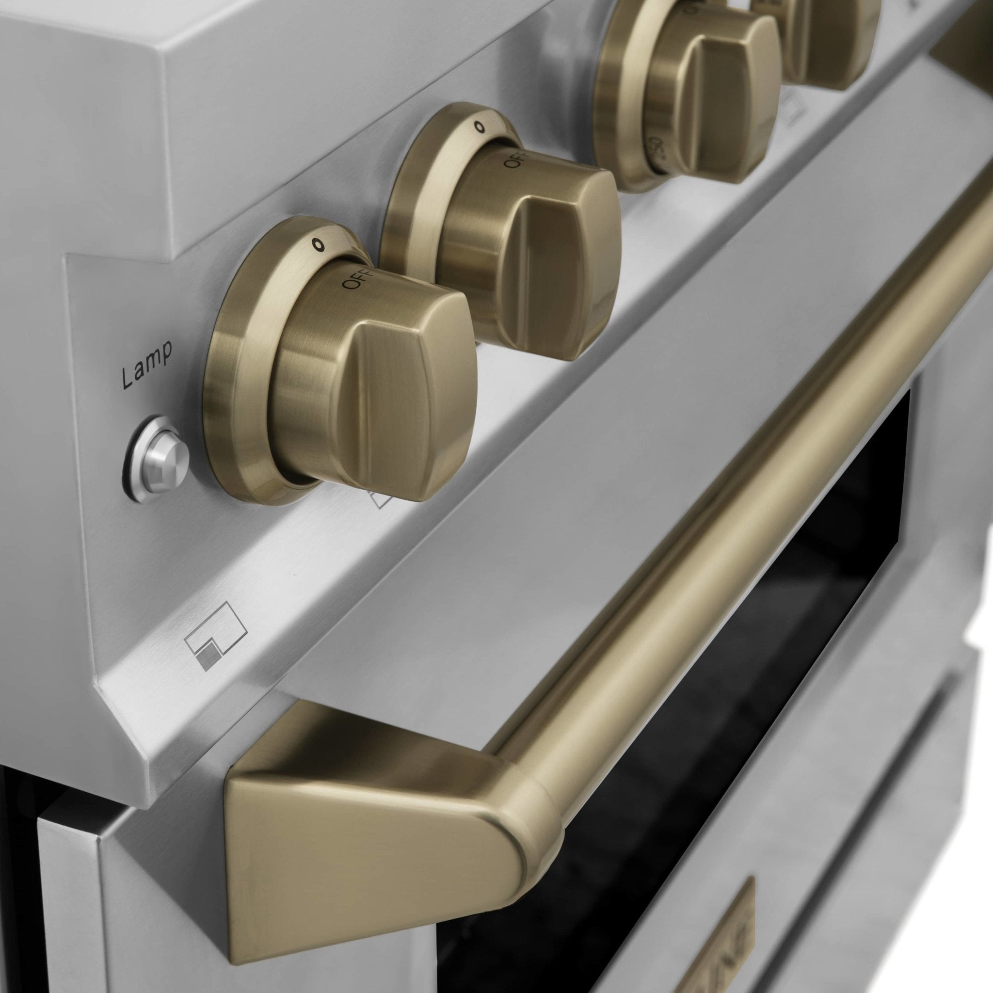 Champagne bronze control knobs on stainless range with open oven drawer area