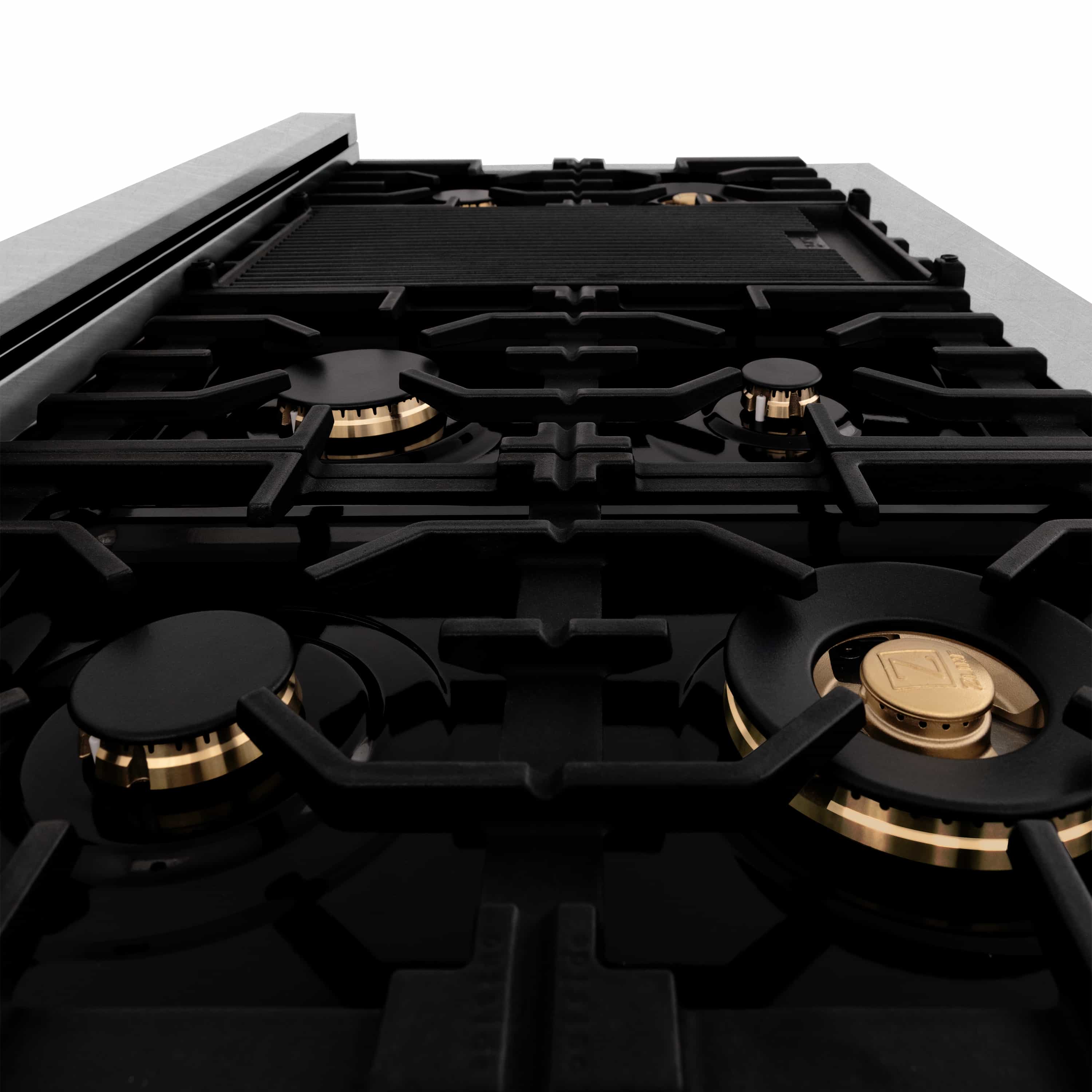 Dual fuel gas cooktop with black grates and gold-accent burners