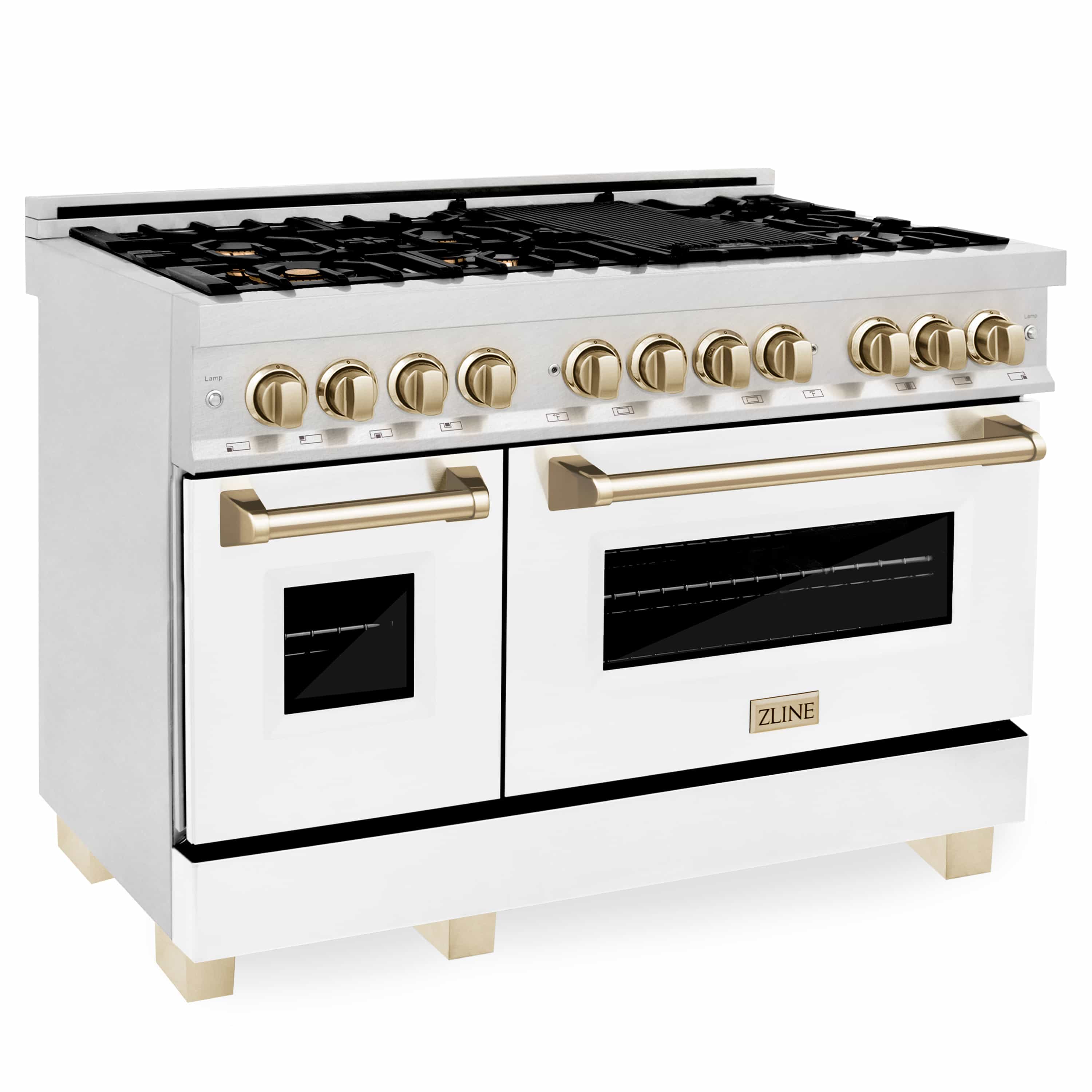 White dual oven range with gold knobs, brass handles, and black glass oven doors