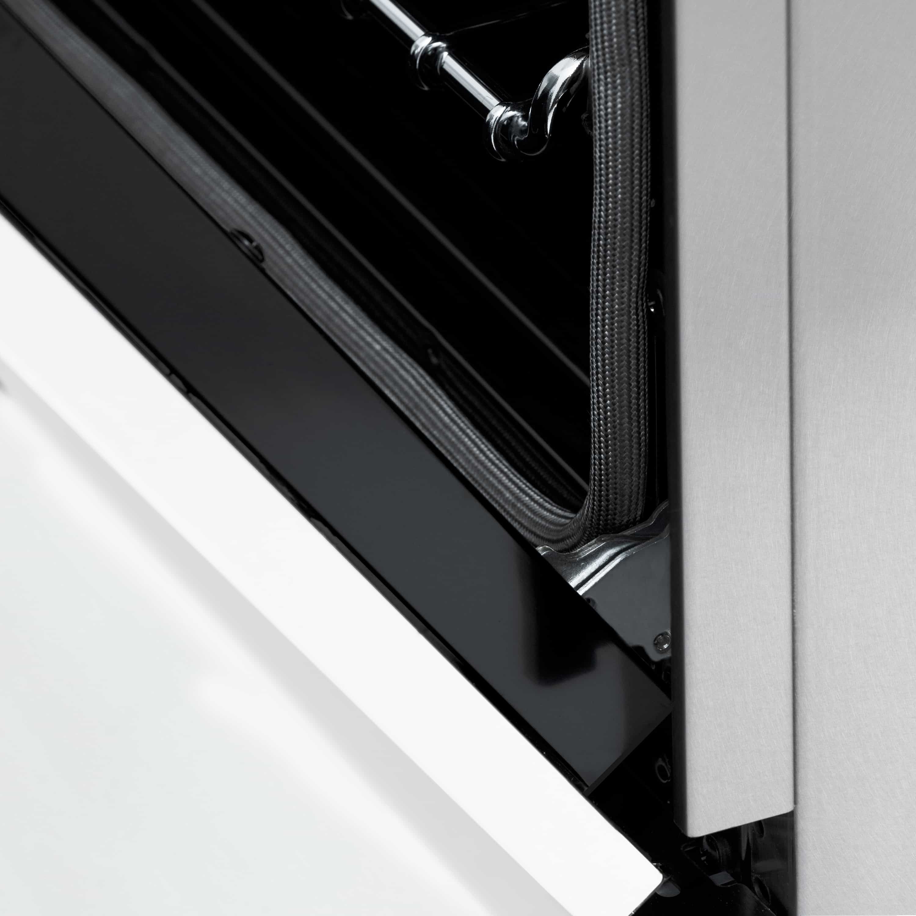 Close-up of oven door seal and black interior with chrome rail