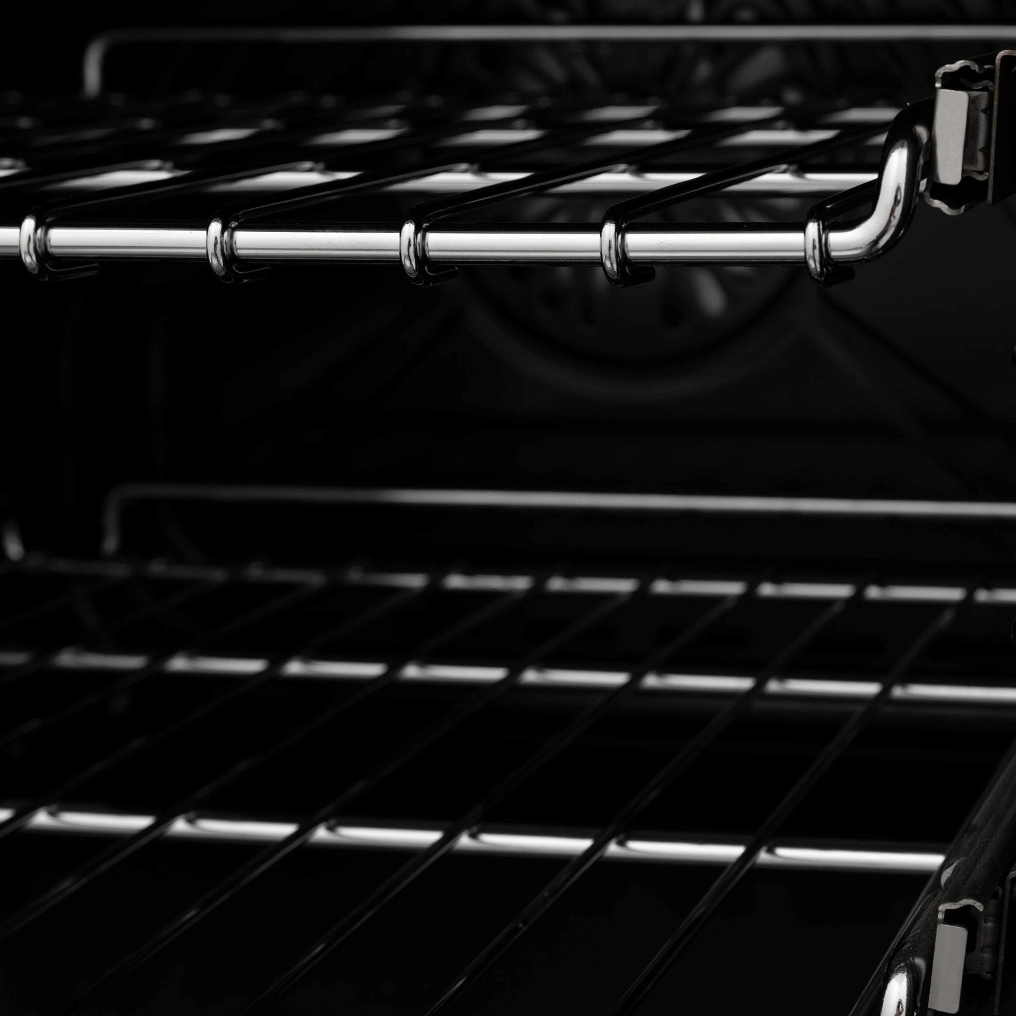 Oven interior with wire rack and dark heating element, black enamel walls