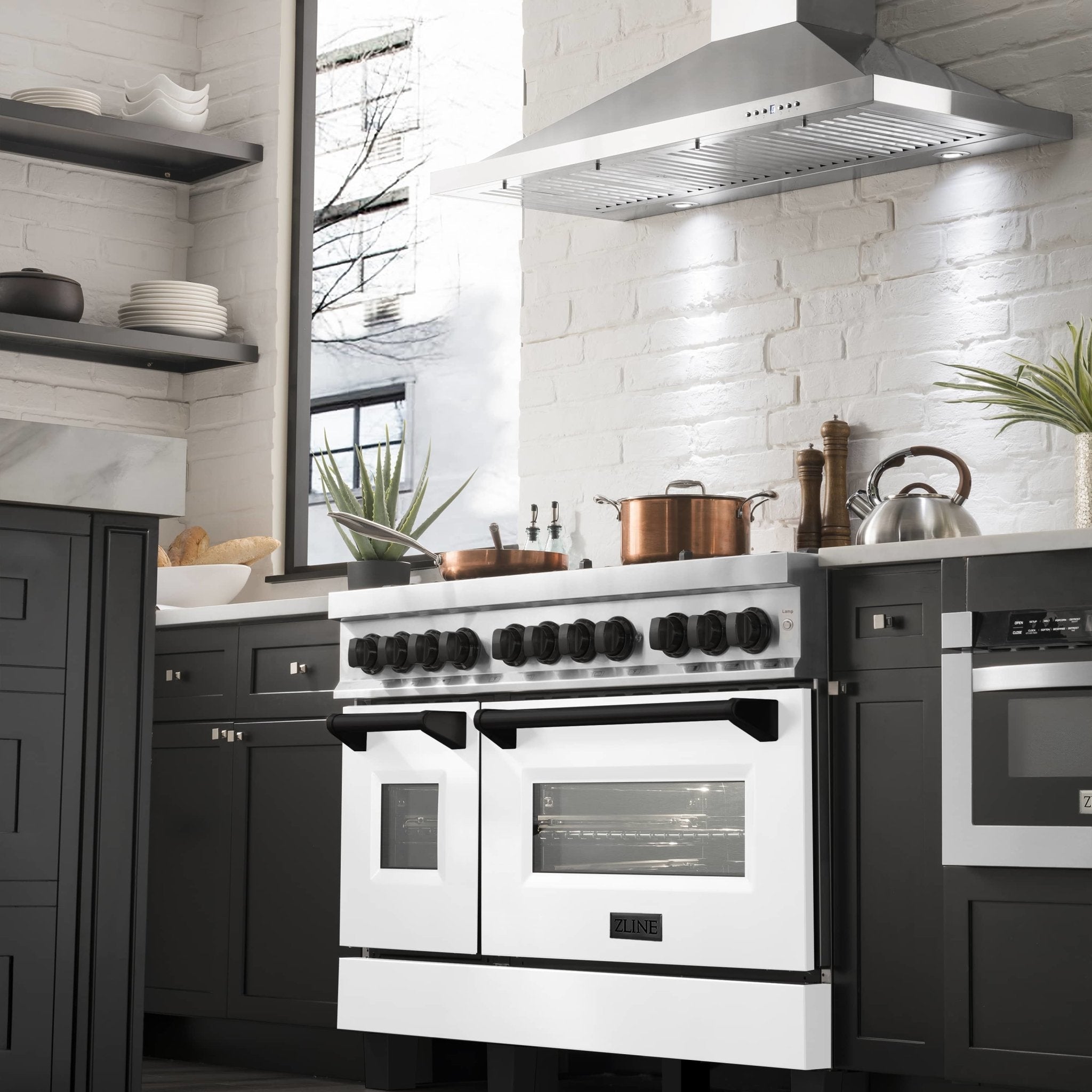 Dual-fuel range in kitchen with white doors, black accents, and stainless control panel