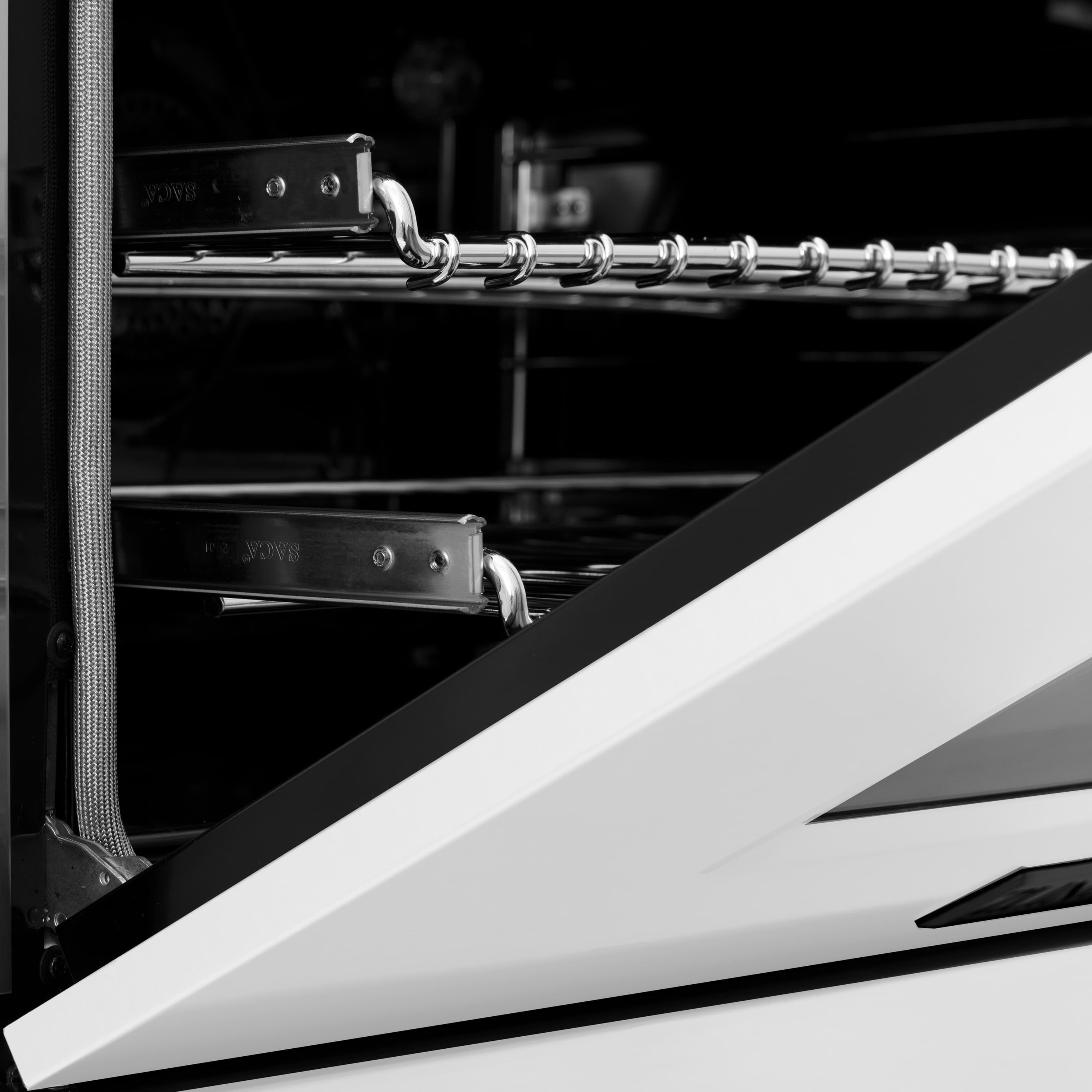 Close-up of oven racks and metal handle inside a white gas range
