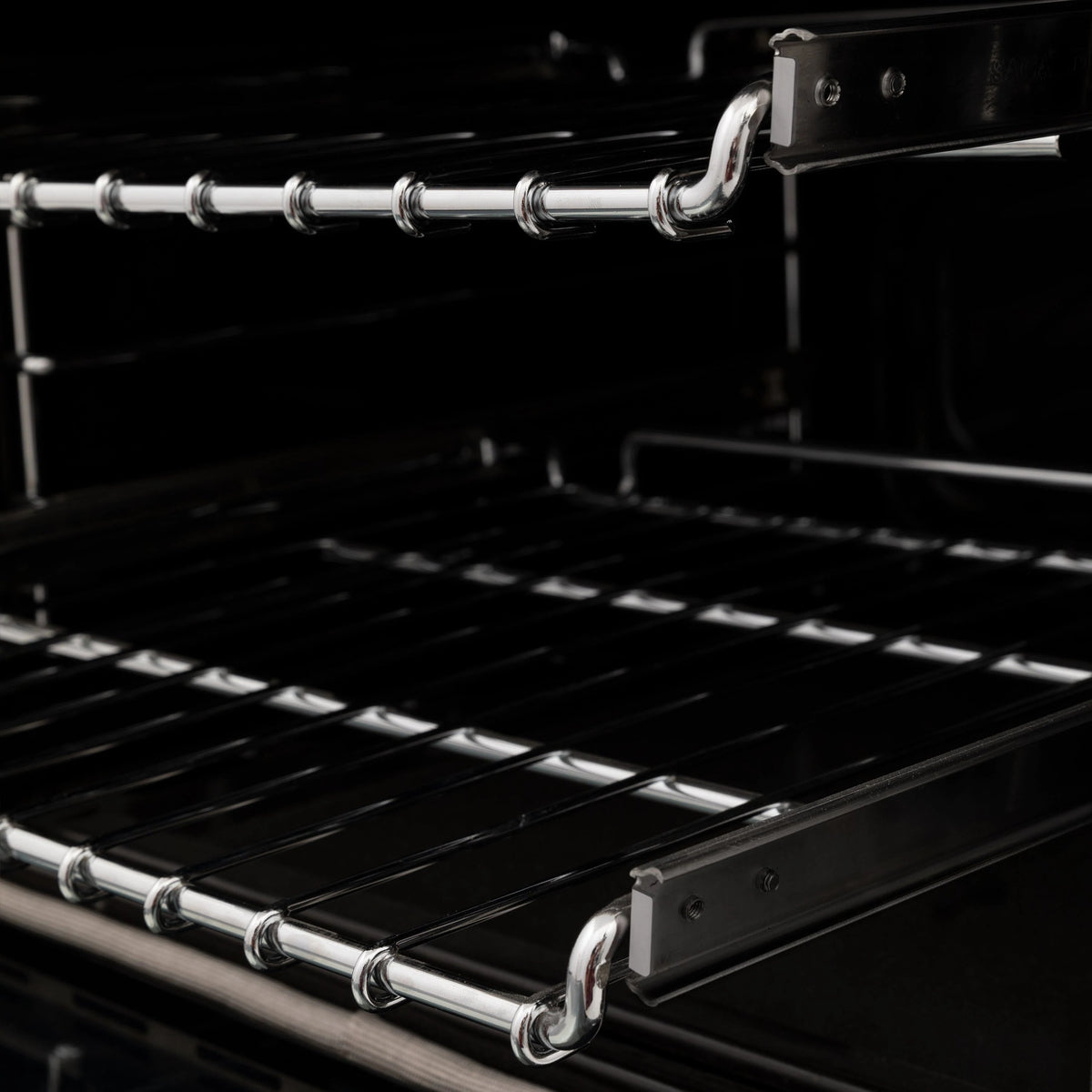 Dual fuel range oven racks with chrome rails inside black oven cavity