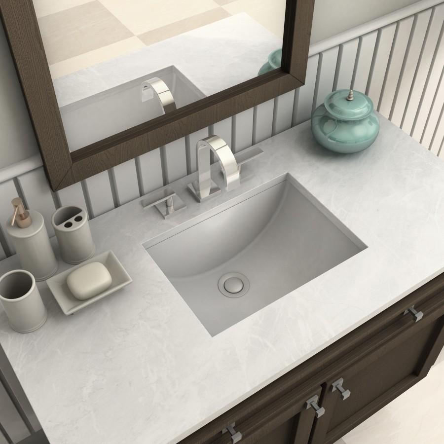 Chrome faucet and sink on vanity with mirror