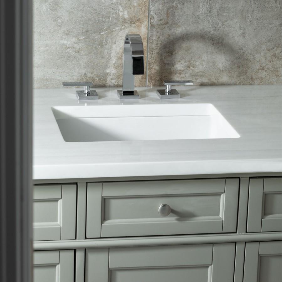 Chrome deck-mount bath faucet with arched spout and two side handles over sink