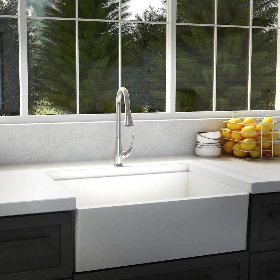 Chrome kitchen faucet on white sink, single-handle curved spout, countertop view