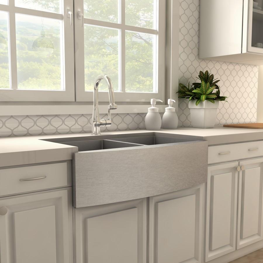 Chrome kitchen faucet with arched spout mounted on countertop