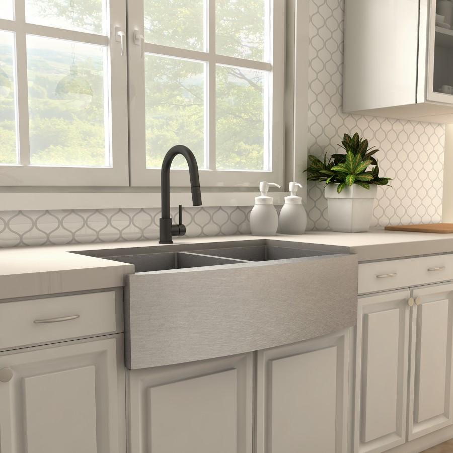 Matte black kitchen faucet over a double-basin sink with pull-down style stream
