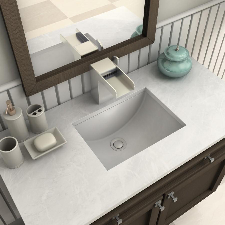 Brushed nickel bath faucet with arched spout and handles over a square sink