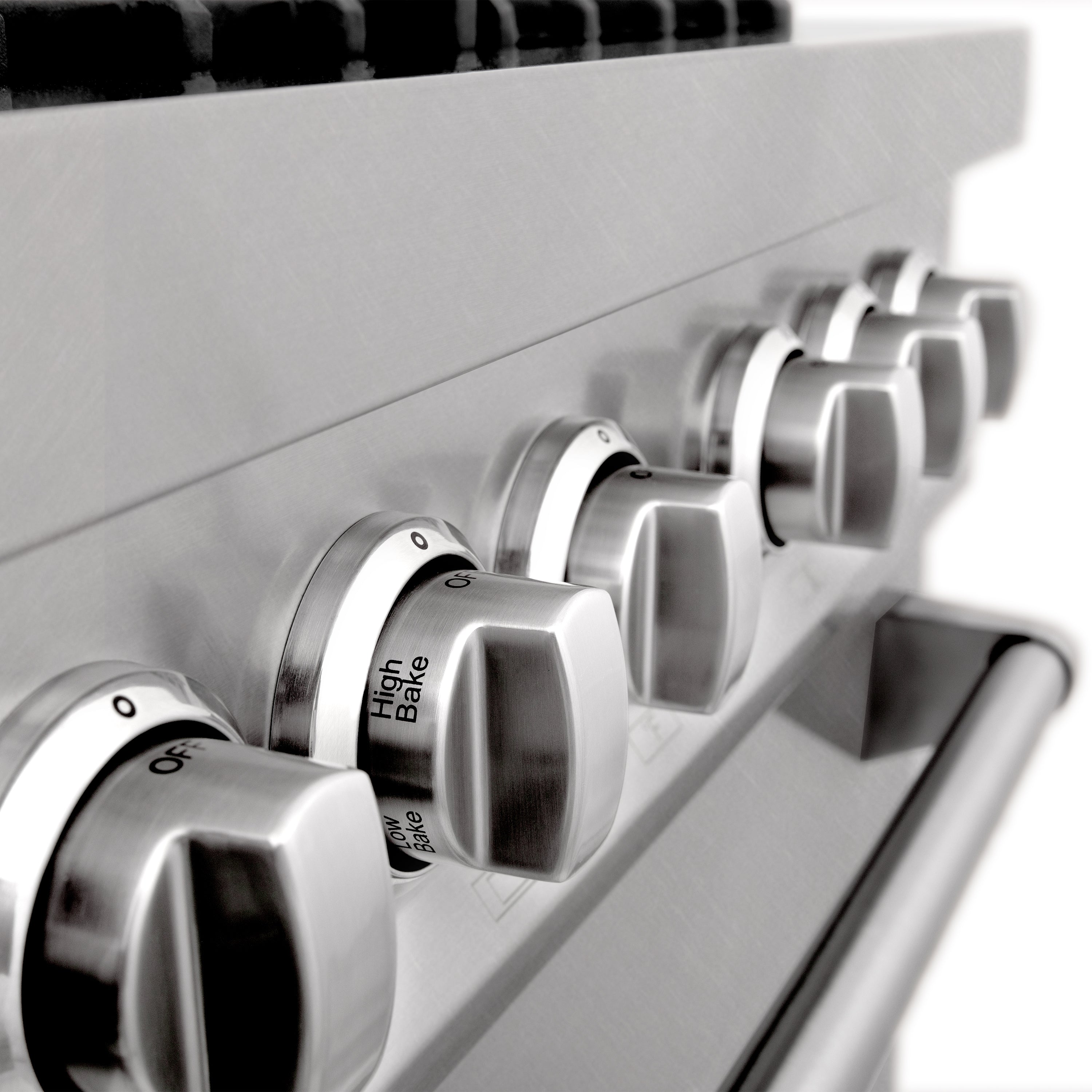 Stainless steel control knobs with labeled settings on dual fuel range front