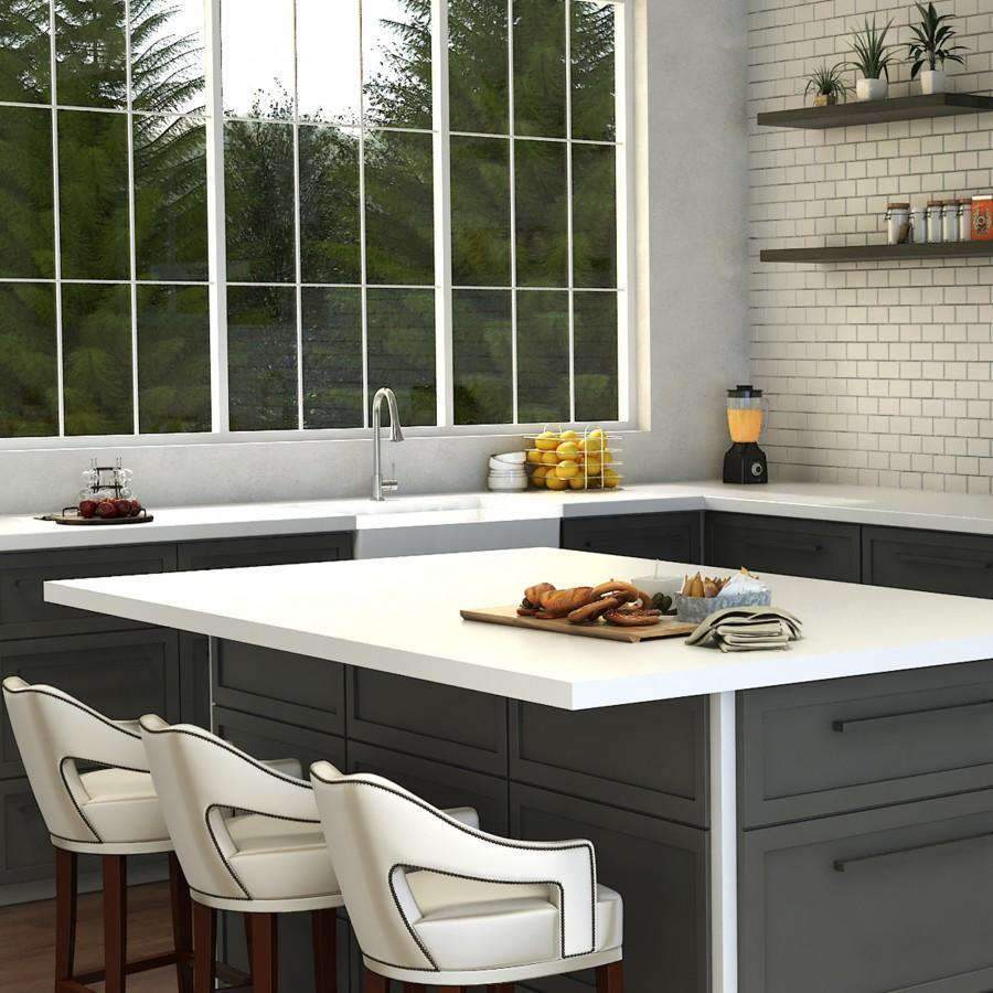 Chrome kitchen faucet over white countertop with sink and backsplash visible