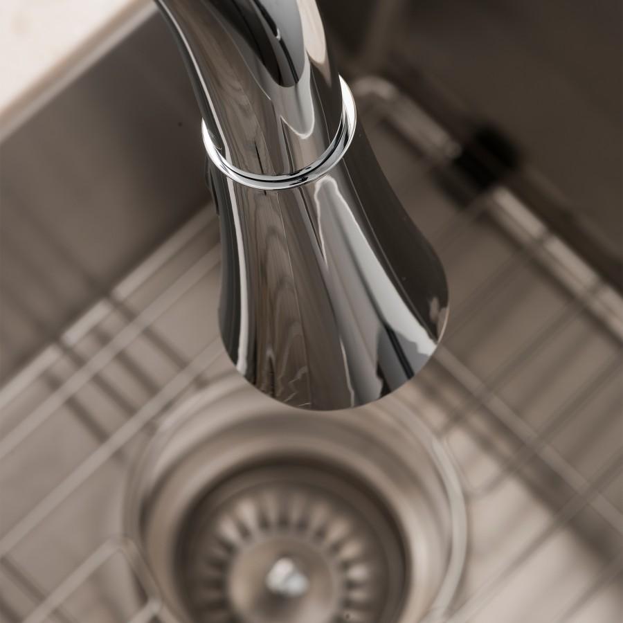 Chrome faucet spout and aerator over sink drain area