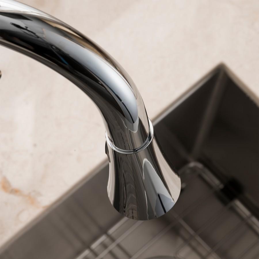 Angled close-up of chrome faucet spout above sink