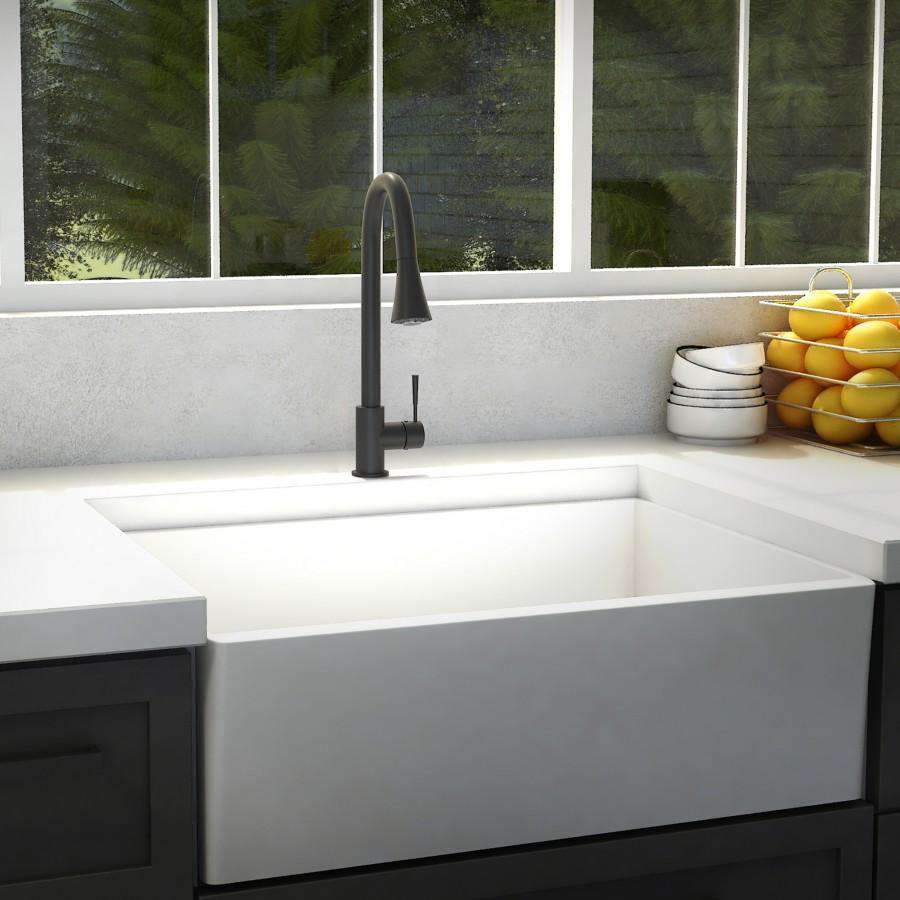 Matte black kitchen faucet with tall curved spout mounted over sink