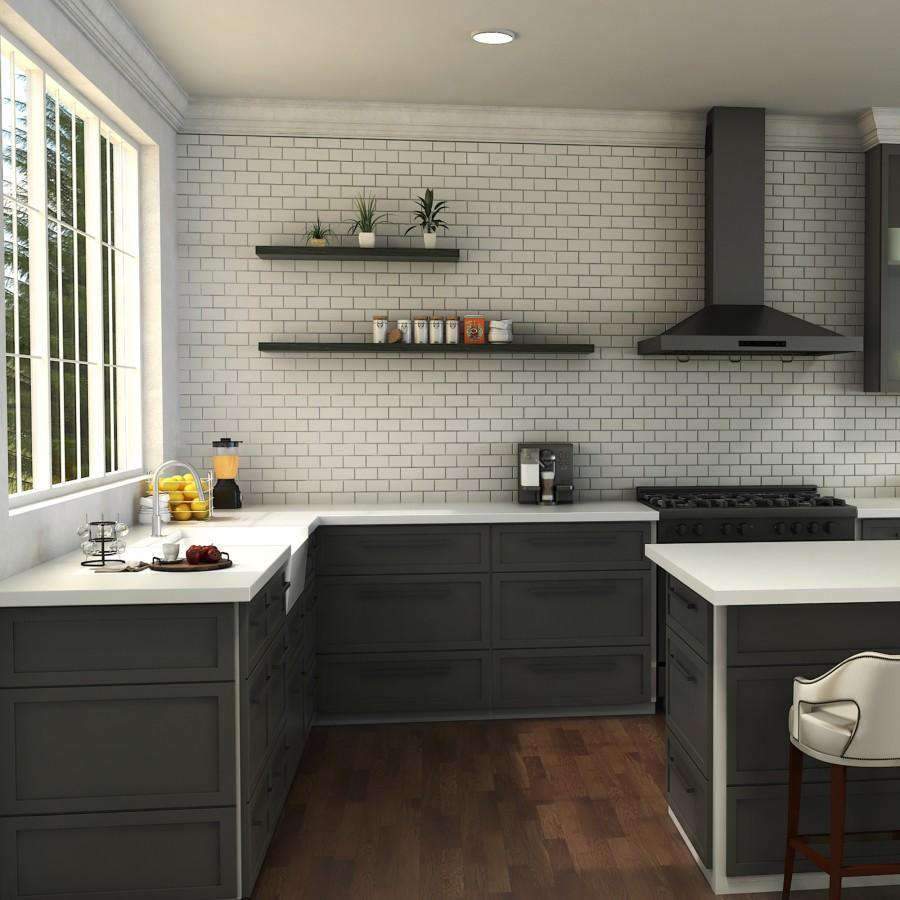 Brushed nickel kitchen faucet with curved spout on white countertop, single lever handle