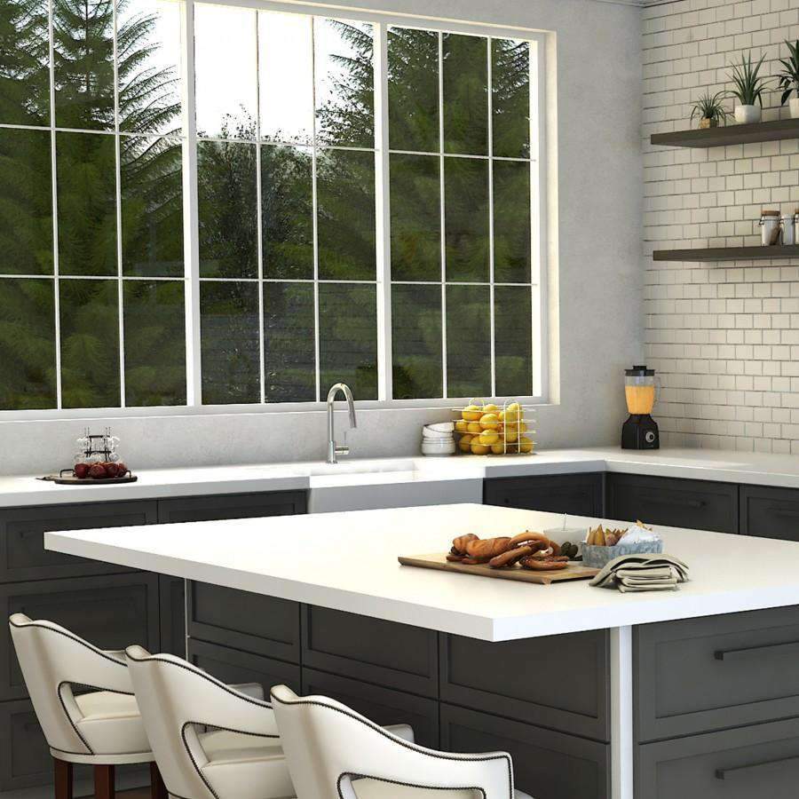 Chrome single-handle kitchen faucet mounted on a white sink countertop