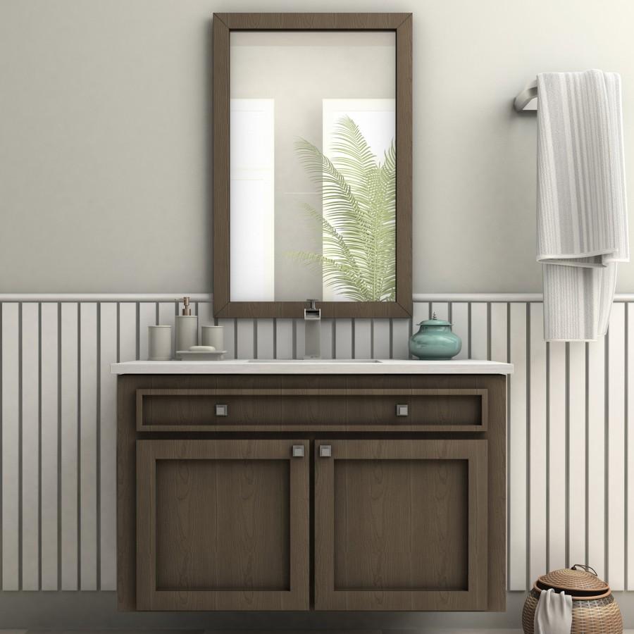 Chrome bathroom faucet on white countertop sink beneath wall mirror