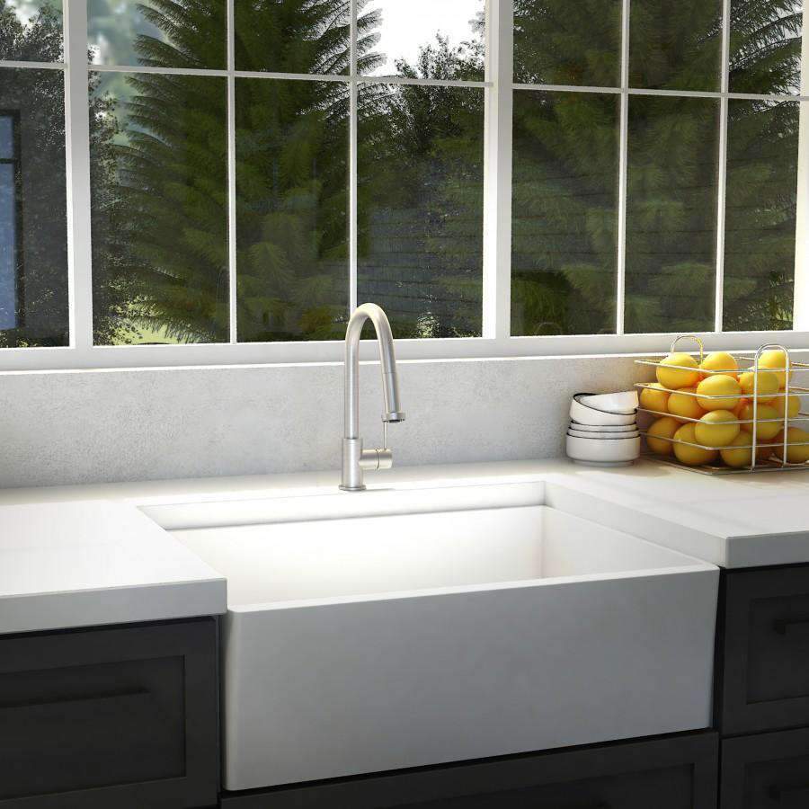 Brushed nickel kitchen faucet with tall arched spout mounted over a white sink