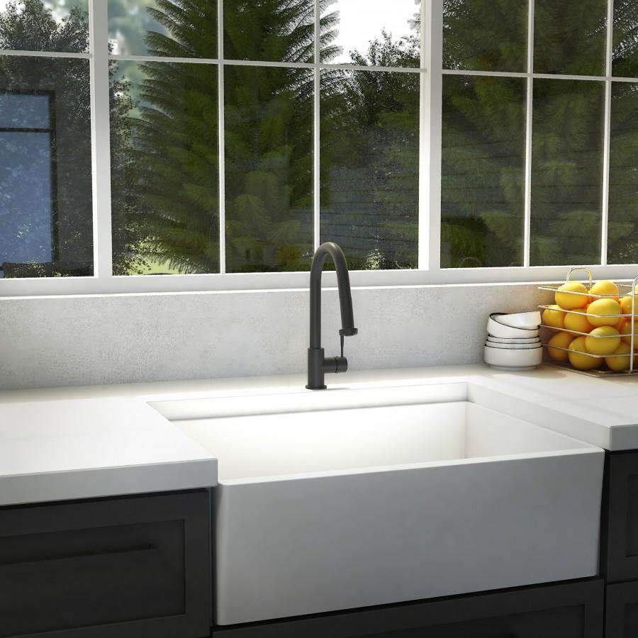 Matte black kitchen faucet over sink with tall arched spout