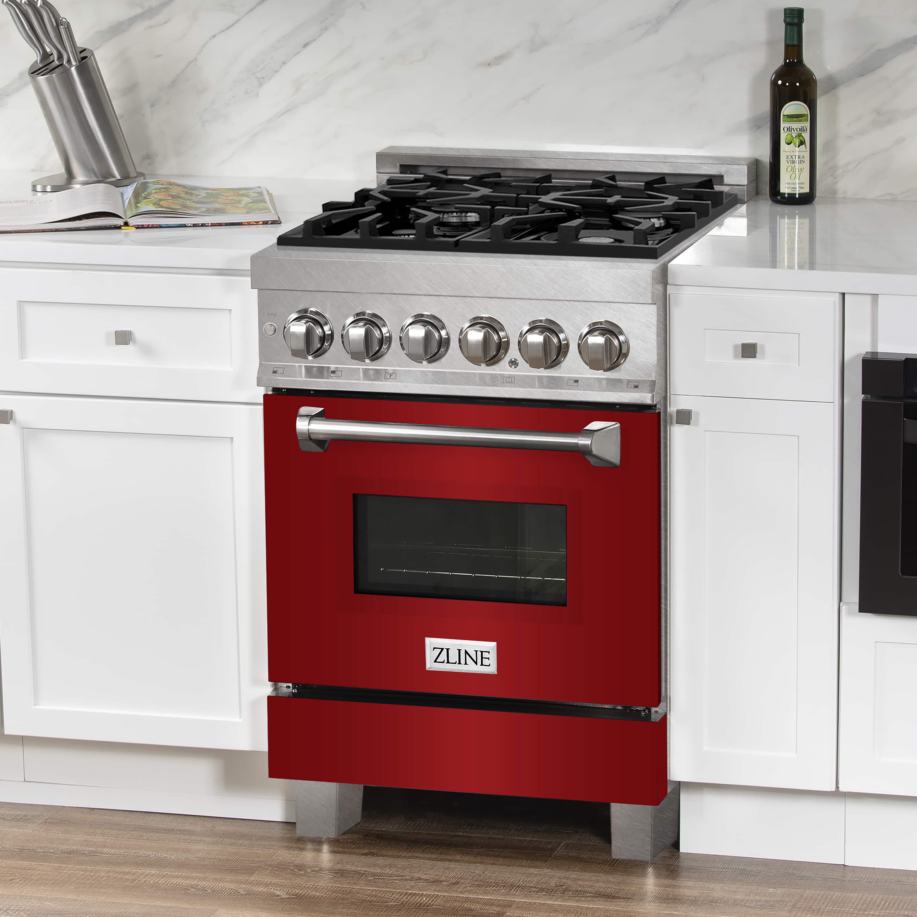 Stainless dual fuel range with red oven door, large window, and six control knobs.