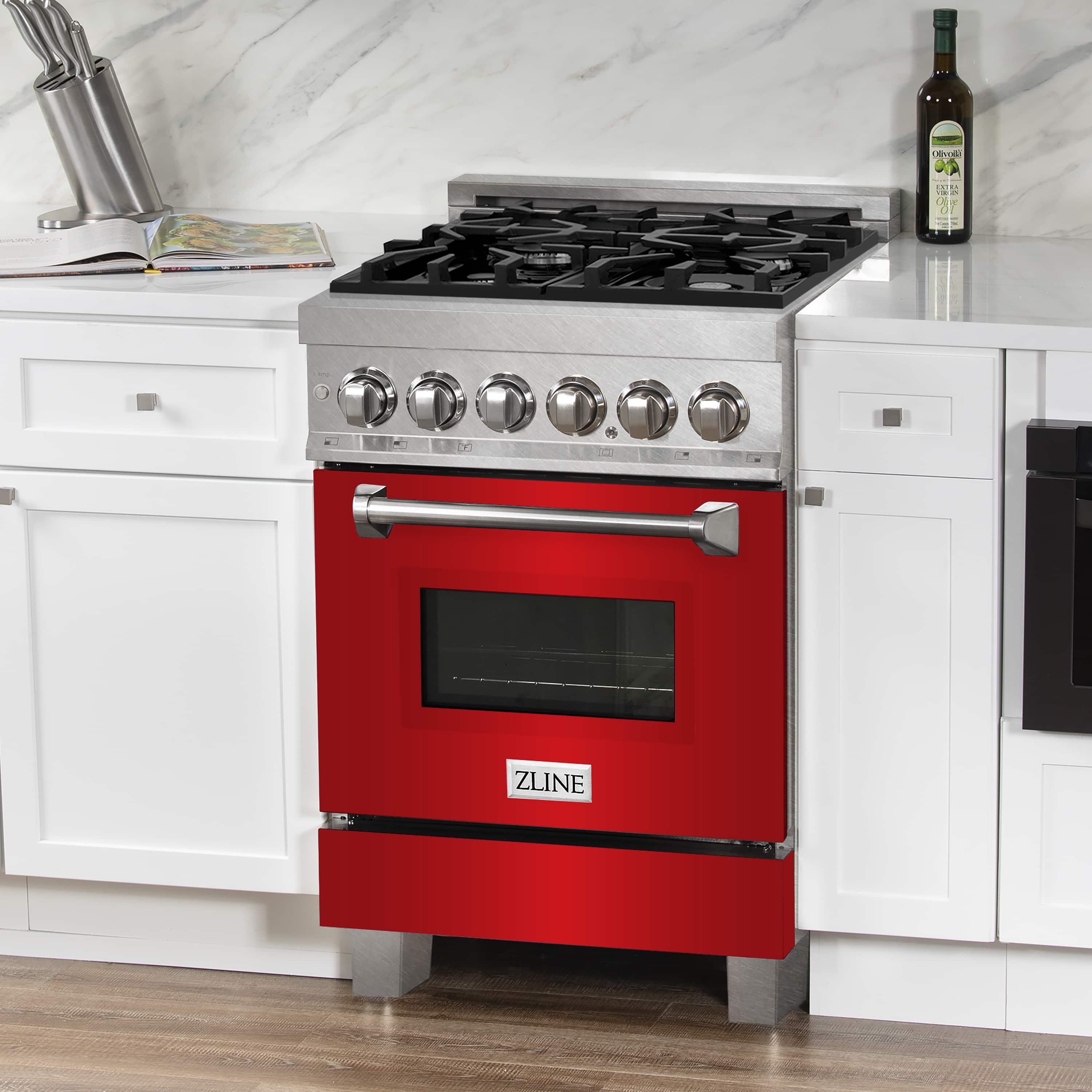 Front view dual fuel range with black burner grates, red oven door, and metal control knobs