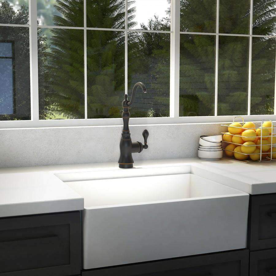 Oil-rubbed bronze kitchen faucet installed over a white countertop sink