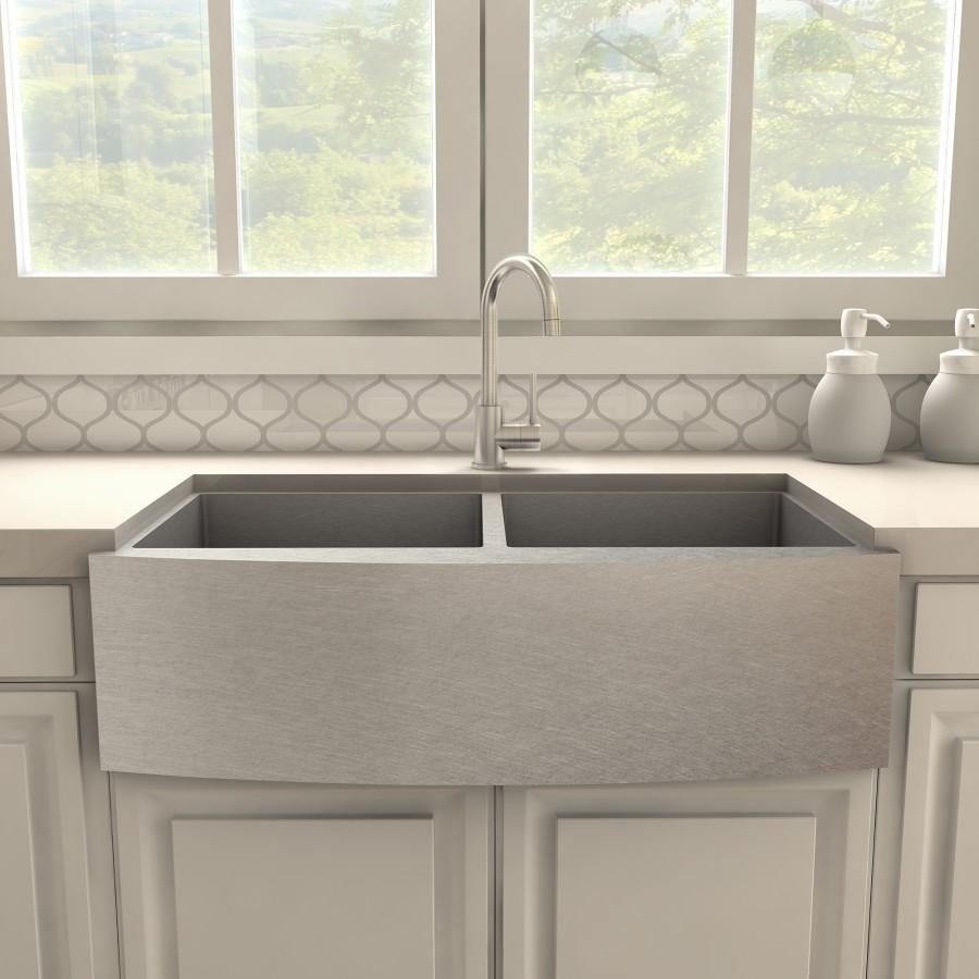 Brushed nickel kitchen faucet centered over apron-front double sink