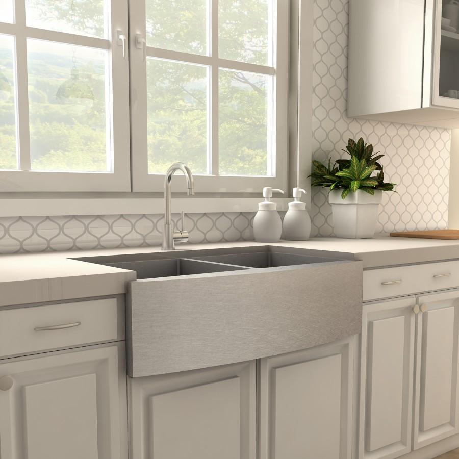 Brushed nickel kitchen faucet installed at double-basin sink in a modern kitchen
