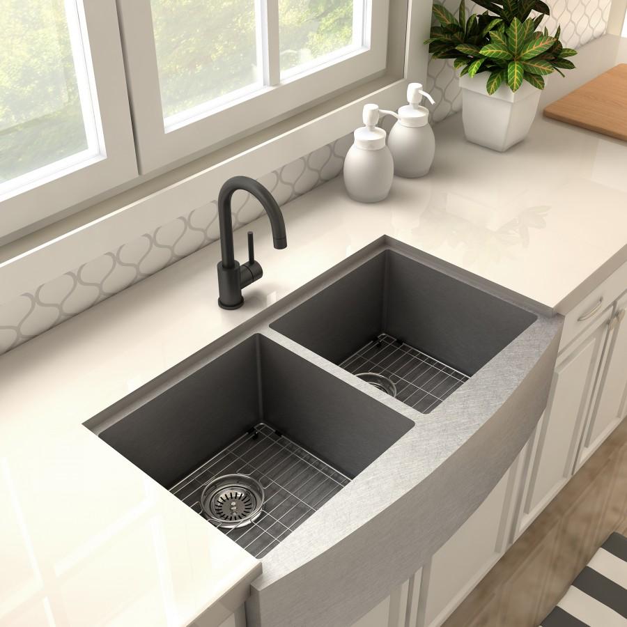 Matte black kitchen faucet with curved spout and side lever on sink deck