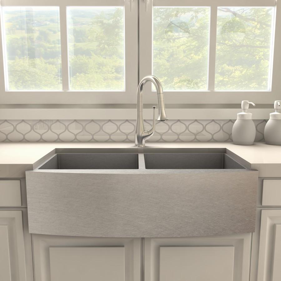 Brushed nickel kitchen faucet mounted on gray double-basin sink