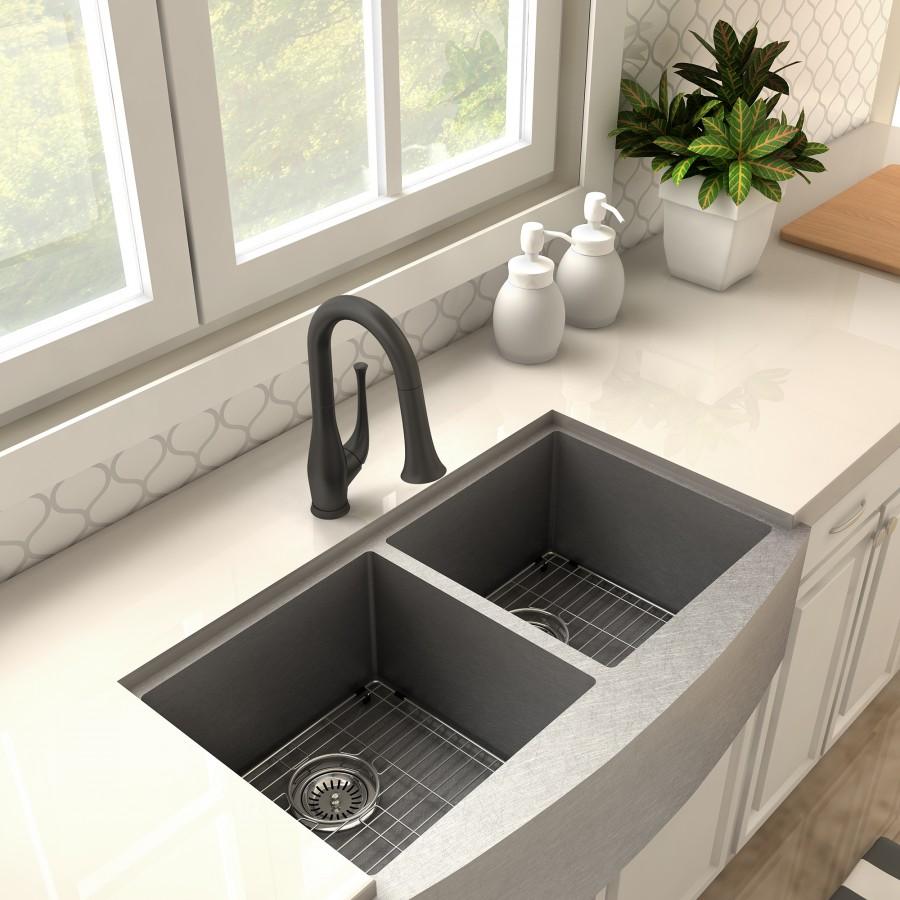 Matte black kitchen faucet over a double sink with drain strainers in place