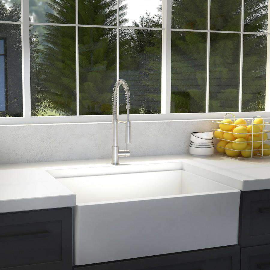 Brushed nickel kitchen faucet with tall spout over undermount sink