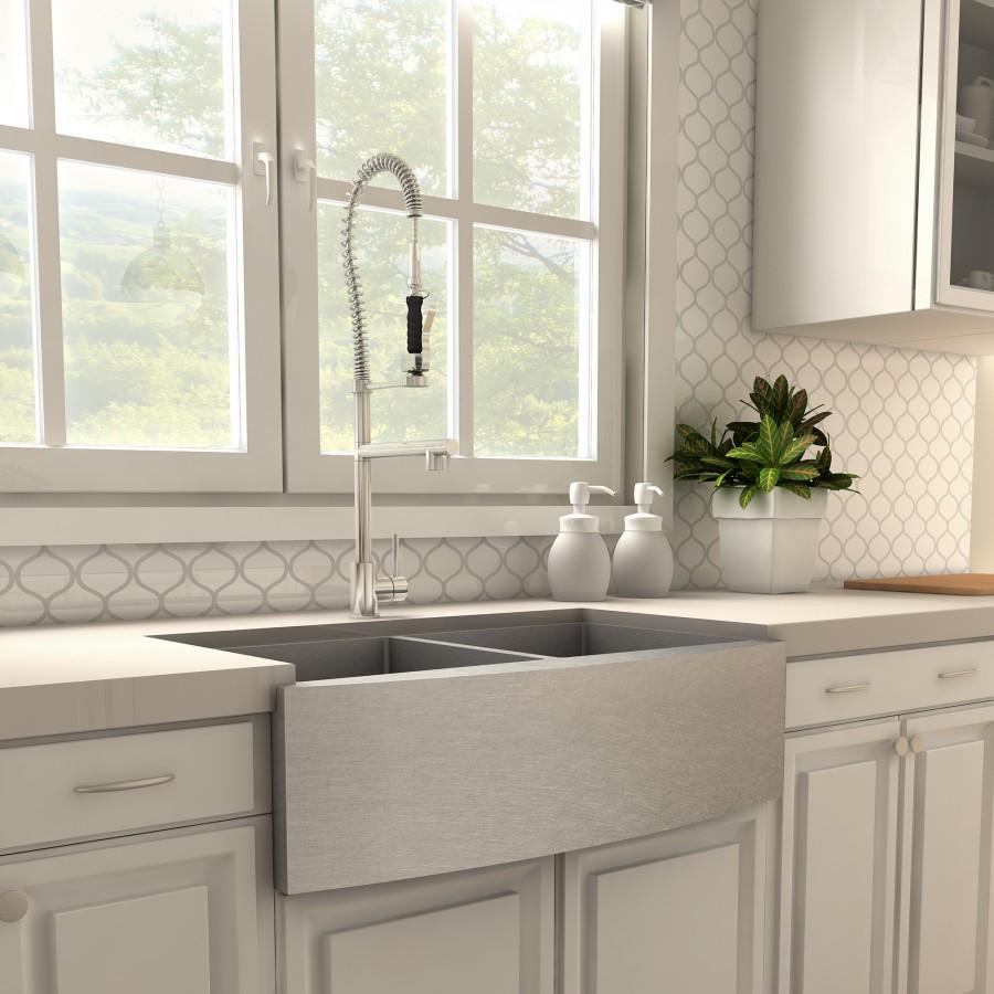 Chrome high-arc kitchen faucet with coiled spring hose and pull-down sprayer