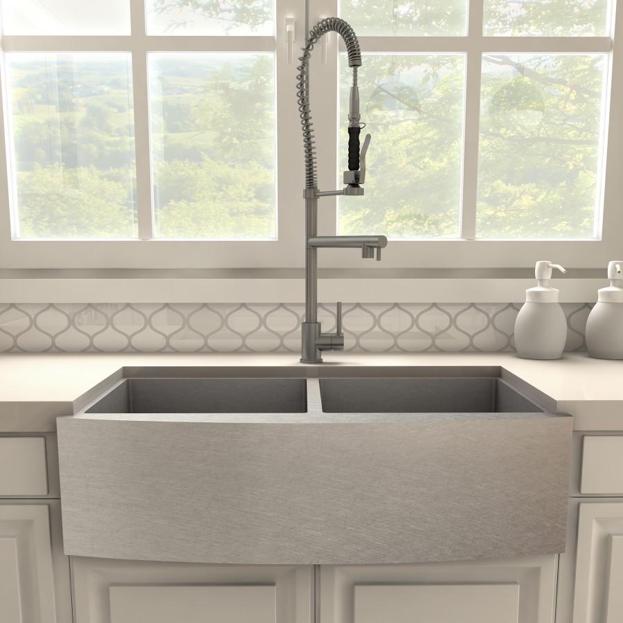 Gun metal kitchen faucet with tall arched gooseneck and coiled spring sprayer hose